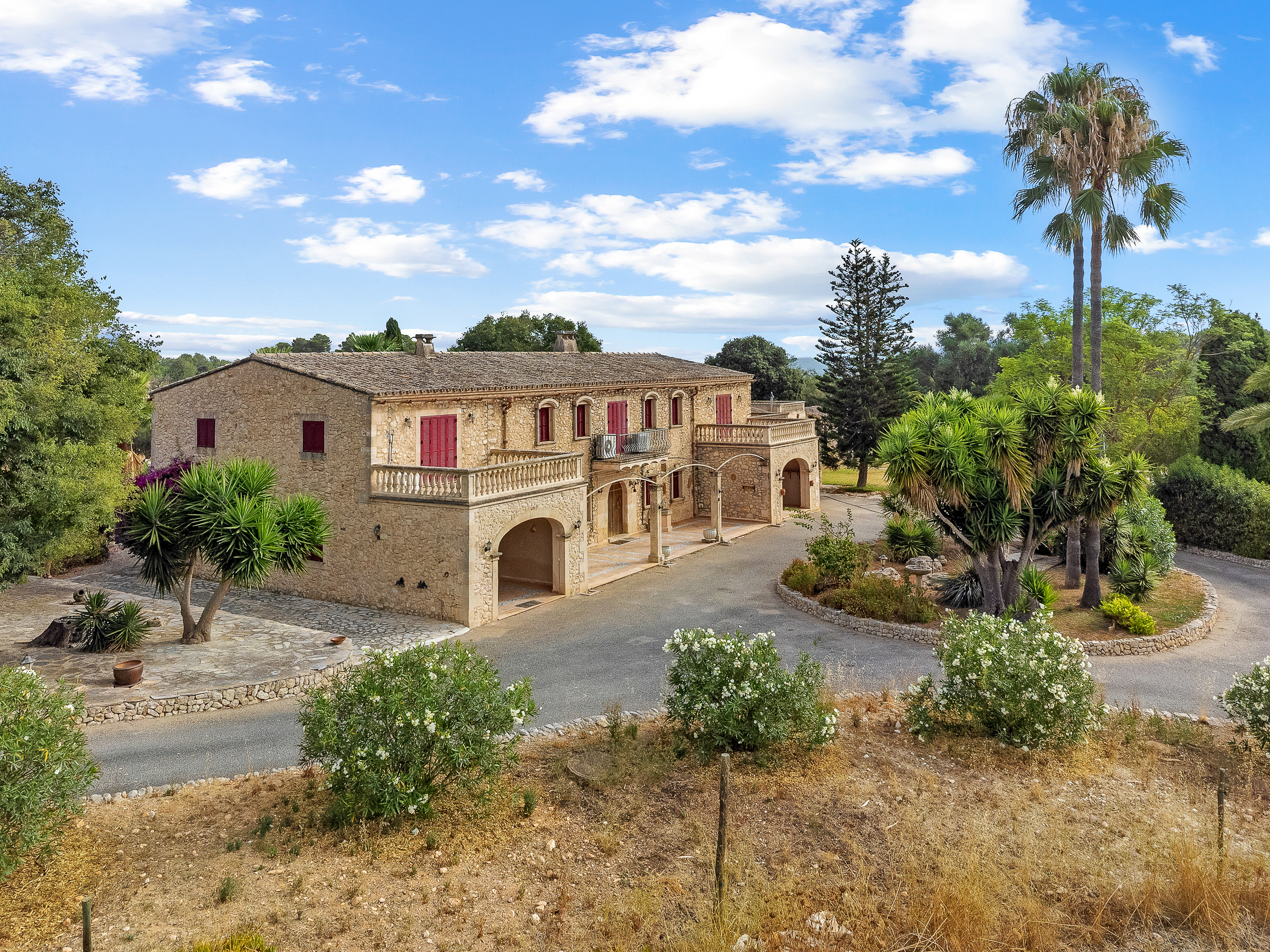 Elevated view of the Mallorcan stone residence and landscaped gardens